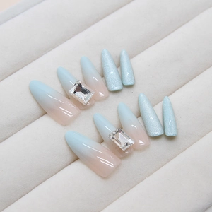 Cat eye press-on nails with luxury rhinestones and blue pink gradient finish