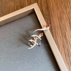 Macro view of double-headed silver snake ring with orange pear-cut zircon gems