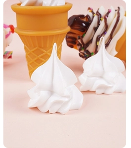 Detailed view of white resin cream flower charms for DIY miniature sundae crafts