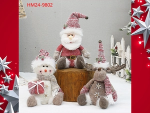 Detailed view of handmade pink Christmas plush figurines with knit fabric and sequin snowflakes