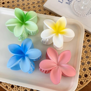 Set of four matte plumeria flower hair claws in tropical summer vacation colors