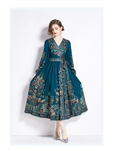 Detailed close-up of bohemian paisley print on a dark teal long-sleeve maxi dress