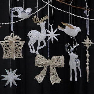 Sparkly white and champagne gold Christmas ornaments including reindeer and stars
