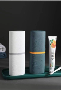 Waterproof portable toothbrush travel case set in white and dark green with water droplets