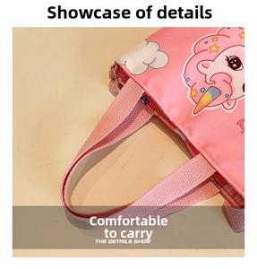 Detail view of the reinforced pink fabric handle on a cartoon unicorn tote bag