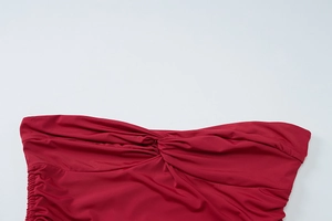 Detailed close-up of dark red fabric showing twist knot design and side drawstring ruching