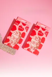 Detail of Valentine's Day press-on nail kits with red heart patterns in gift packaging