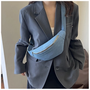 Blue denim half-moon waist bag with golden zipper and adjustable fabric strap