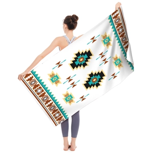 Detailed view of large microfiber beach towel with ethnic geometric patterns on model