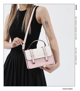 Detail showing the pink and white crossbody bag with adjustable strap on a model