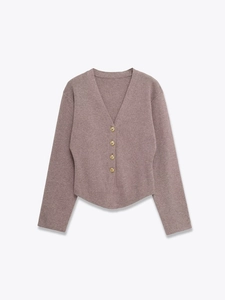 Close-up of four delicate gold buttons on a soft mauve knitted cardigan for women