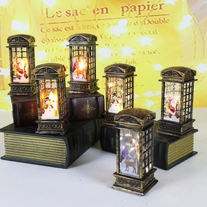Retro Christmas telephone booth lanterns with Santa and snowman patterns on vintage books
