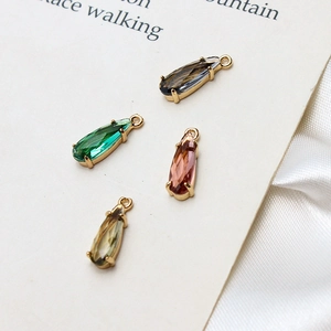 Detail showing colorful teardrop glass pendants with gold-plated claw settings for DIY jewelry