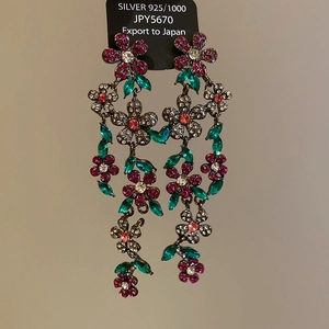 Detail of floral tassel earrings featuring colorful rhinestones and 925 silver needles