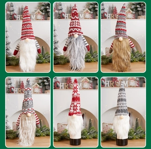 Detailed view of six different knit Christmas gnome wine bottle covers for holiday decor