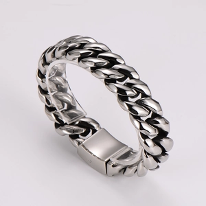 Detailed close-up of thick silver stainless steel Cuban link chain with polished finish