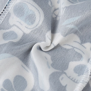 Detailed macro view of breathable mesh fabric with skull print and blue stitching