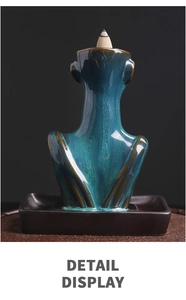Ceramic backflow incense burner detail with peacock blue glaze and elegant figurine curves