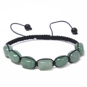 Close-up of green oval stone beads on a black hand-woven adjustable cord bracelet