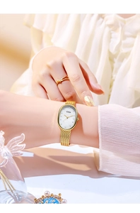 Detail of elegant gold oval watch with mother-of-pearl dial on a woman's wrist