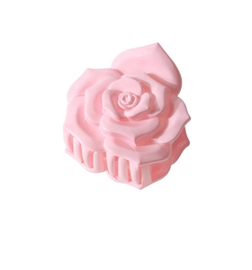 Détail de la pince à cheveux rose en forme de rose 3D avec texture de résine polie