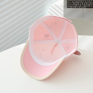 Internal structure of pink kids baseball cap showing breathable lining and seam details
