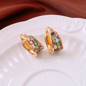 Detail view of 18K gold plated U-shaped earrings with colorful abalone shell and cubic zirconia