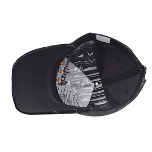 Macro view of washed black cotton baseball cap interior with 100% cotton label