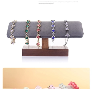Detail showing various heart-shaped gemstone bracelets displayed on a wooden jewelry stand