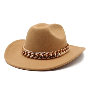 Detail of camel wool felt fedora featuring a bold polished gold Cuban link chain decoration