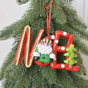 Christmas tree clay ornament featuring Santa and red ME letters on a pine branch