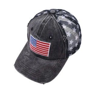 Detail view of American flag patch and star print mesh on the vintage trucker hat