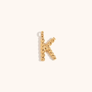 Detailed close-up of 18K gold-plated twisted rope letter K pendant with smooth metallic texture