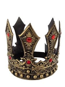 Close-up of vintage bronze king crown with intricate textures and red faceted gemstones