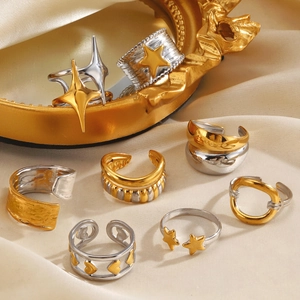 Mix of vintage star and heart stainless steel rings on premium silk fabric background