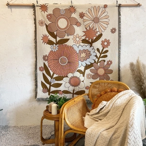 Bohemian floral cotton blanket with tassels hanging as a decorative wall tapestry