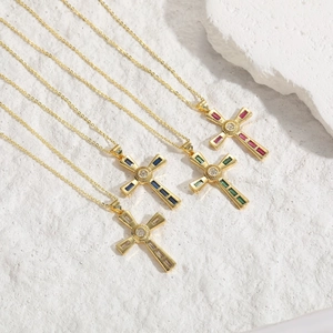 14K gold plated cross pendant necklaces with colorful zircon stones on white stone background