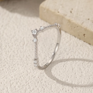 Elegant S925 sterling silver V-shaped ring with pavé stones on textured beige stone