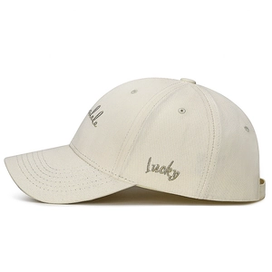 Beige cotton baseball cap with Lucky embroidery and curved brim in side view