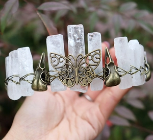 Macro detail of raw white crystal quartz and bronze butterfly filigree on Viking crown