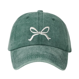 Dark green washed cotton baseball cap with white bow embroidery in a minimalist front view