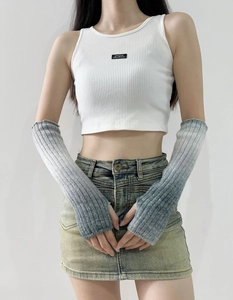 Detailed texture of gradient grey ribbed knit arm warmers with fingerless design