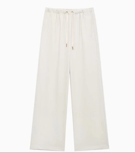 Detail showing high-waisted wide-leg trousers in cream with adjustable drawstring waist