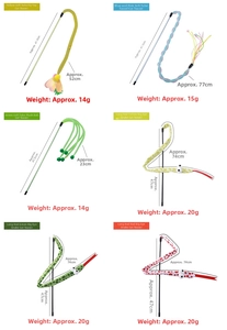 Close-up of various interactive cat wands with colorful feathers and bells for kittens