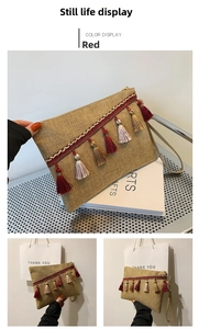 Detail of linen envelope clutch with red trim and colorful tassels with a wristlet strap