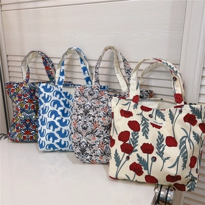 Detail view of assorted vintage floral and cat print cotton canvas mini tote bags
