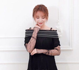 Detail showing elegant black mesh lace sleeve covers with delicate white embroidery accents
