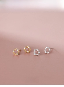 Detailed view of S925 silver wreath stud earrings with zircon leaves in gold and silver