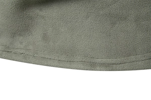 Close-up of military green fleece hoodie fabric showing high-density texture and double stitching