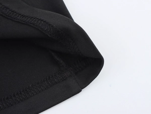 Detailed view of black organza fabric stitching and professional double-needle edge finishing